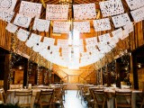 white lace banners, lit up trees, neutral linens, greenery make this barn wedding reception space