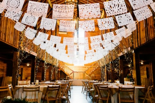 white lace banners, lit up trees, neutral linens, greenery make this barn wedding reception space