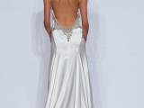 a chic mermaid wedding dress of plain fabric, with an open back and embellished edges is a fantastic statement that looks wow