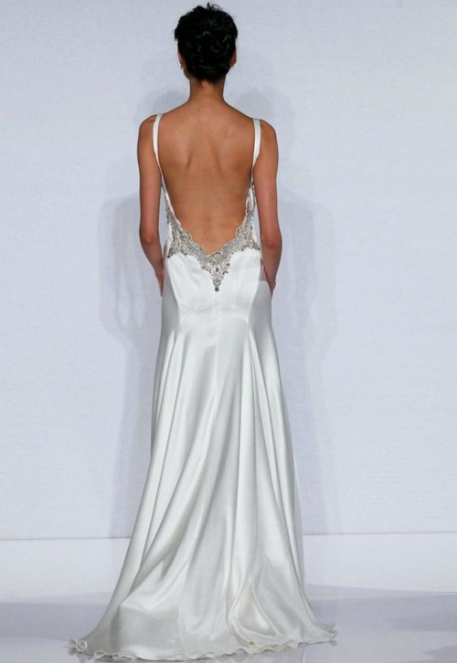 a chic mermaid wedding dress of plain fabric, with an open back and embellished edges is a fantastic statement that looks wow