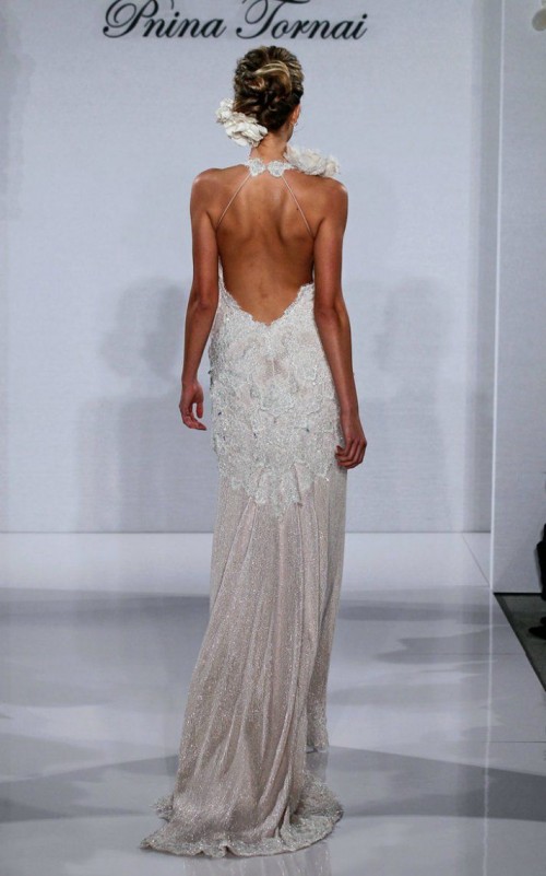 an embellished mermaid wedding dress with an open back, lace appliques and lace blooms on the front is wow