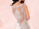 a dreamy floral fitting wedding dress with an illusion back done with floral appliques and lace that marks the edges is very enchanting