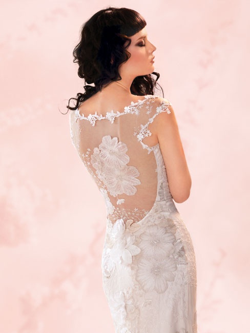 a dreamy floral fitting wedding dress with an illusion back done with floral appliques and lace that marks the edges is very enchanting