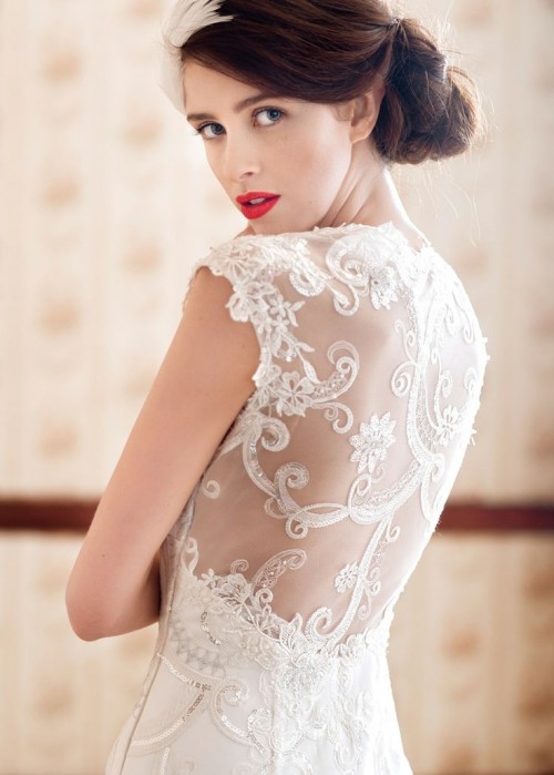 a delicate vintage lace fitting wedding dress with cap sleeves and an illusion back with lace appliques is gorgeous