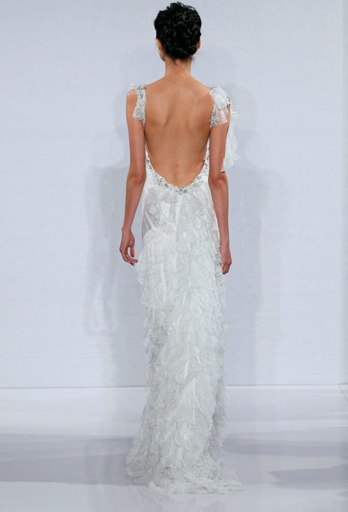 a catchy ruffle and embellishments mermaid wedding dress with an open back with ties on the shoulders and a small train is a sexy statement