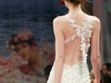 a charming floral mermaid wedding dress with an open back accented with lace flower garlands is a dreamy idea for a fairy-tale bride