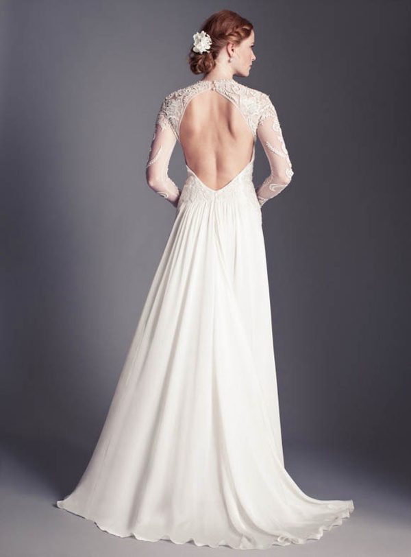 A beautiful A line wedding dress of a lace bodice and illusion sleeves, a plain pleated skirt with a train and an open back is amazing