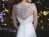 a fitting pleated mermaid wedding dress with an illusion back embellished and with lace, with pearl and bead buttons is a beautiful idea
