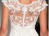 a refined and chic illusion back with lace and embellishments with a row of shiny buttons is a lovely idea for a bride who loves a slight vintage feel
