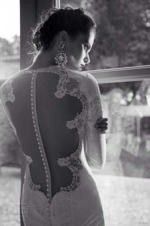 a modern refined fitting wedding dress with an illusion back, with lace, rhinestones and a row of pearly buttons is fantastic