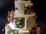 a Lego wedding cake with fall leaves, bright touches, apples and toppers for a fall playful wedding