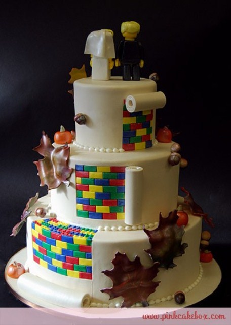 a Lego wedding cake with fall leaves, bright touches, apples and toppers for a fall playful wedding
