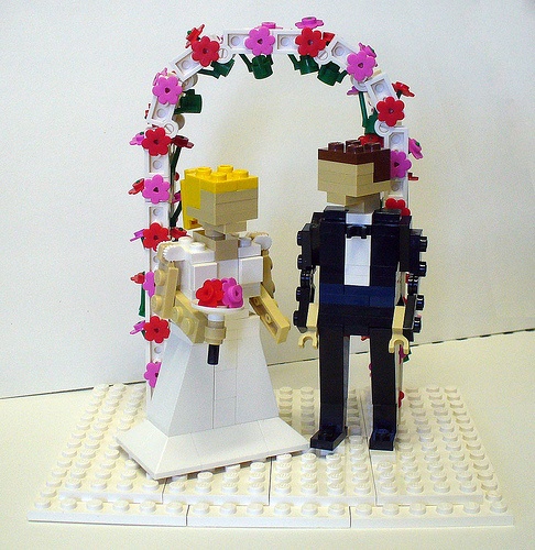 a Lego wedding arch with blooms and Lego figurines are an amazing wedding decoration to rock