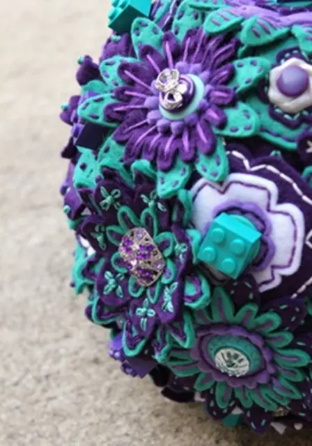a button and brooch wedding bouquet in purple and turquoise with some Lego details