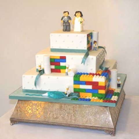 a white Lego wedding cake with colorful touches and cake toppers for a playful wedding