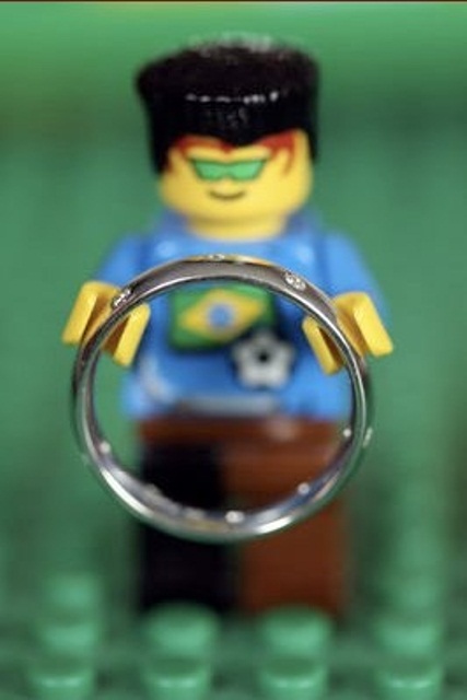 a Lego figurine holding a wedding ring is a cool idea for a photo