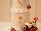 a white tower wedding cake with Lego figurines and a carriage and more figurines is ultimate fun for your dessert table