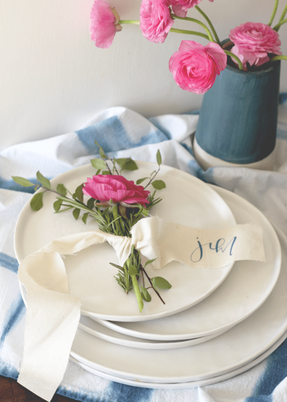 Picture Of lovely diy rosemary and ranunculus place card table settings  3
