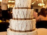 a white textural buttercream wedding cake with burlap, twigs is a cool dessert for any rustic wedding