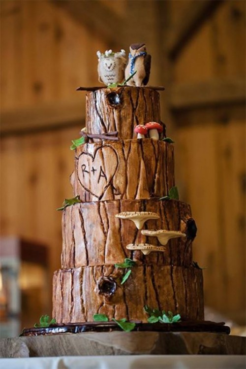 a rustic bark wedding cake with faux mushrooms and leaves and some owl toppers for a rustic or woodland wedding