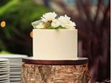 a simple rustic wedding cake with buttercream and white blooms on top is a cool idea not only for a rustic wedding but for many others, too