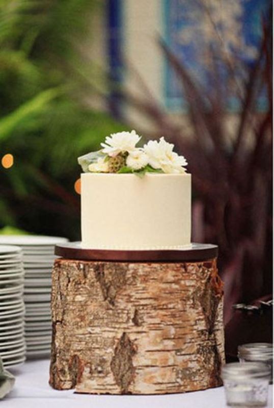 A simple rustic wedding cake with buttercream and white blooms on top is a cool idea not only for a rustic wedding but for many others, too