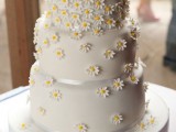 a white buttercream wedding cake decorated with white sugar blooms looks veyr informal, rustic and relaxed