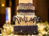 a refined rustic wedding cake in white and purple, with lace, sleek and textural tiers and some lavender and vine