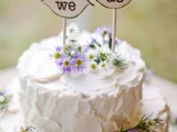 a white textural wedding cake with wildflowers and wood burnt toppers is ideal for many rustic weddings