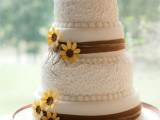 a white patterned and sleek wedding dessert with brown burlap ribbons and sugar blooms plus a monogram topper