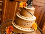 a bark wedding cake with bold blooms, a horse pic and a very romantic cowboy-style cake topper