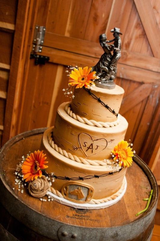A bark wedding cake with bold blooms, a horse pic and a very romantic cowboy style cake topper