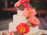 a white textural buttercream wedding cake with bright pink blooms and succulents is a gorgeous piece for a rustic wedding