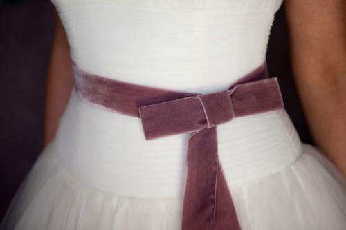 a delicate mauve velvet sash with a bow is a lovely solution for a wedding, it will add a slight touch of color to your look
