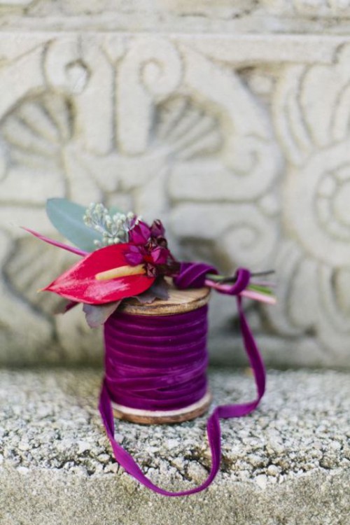 a bright wedding boutonniere of bright blooms and greenery wrapped with fuchsia velvet ribbon is a lovely idea for a jewel-toned wedding