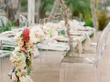 a lush neutral and bright floral garland with some greenery continues the beachy theme in decor