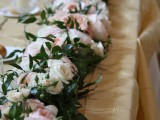 a lush greenery and pastel flower garland looks very tender and very romantic