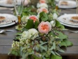a lush greenery and peachy bloom table garland is a cool idea for a rustic or any other wedding