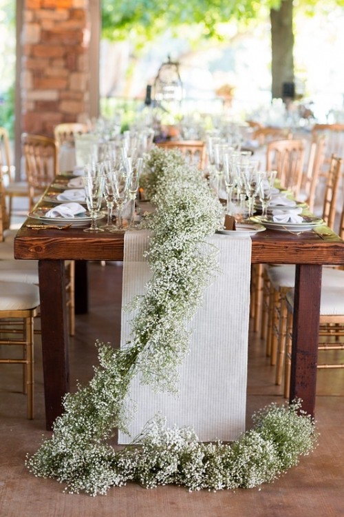 a lush baby's breath table garland paired with a fabric table runner is classics that always works