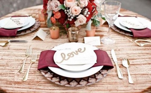 a floral centerpiece with burgundy and marsala blooms and marsala napkins make the tablescape chic and refined and bring elegance