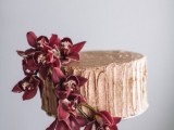 a gold wedding cake with plenty of texture and marsala blooms is a refined and beautiful dessert to rock