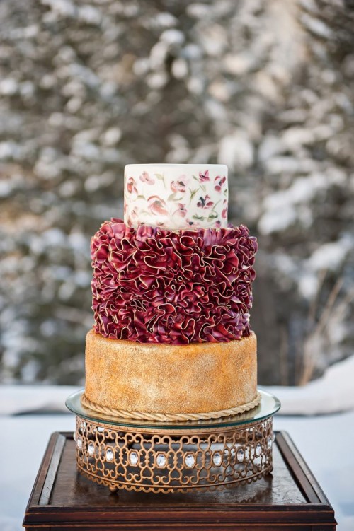 a unique wedding cake with a naked tier, a marsala ruffled one and a floral tier on top looks very refined, beautiful and unique