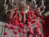 a chandelier with hanging marsala blooms is a refined and unique wedding decoration that you may rock indoors anytime