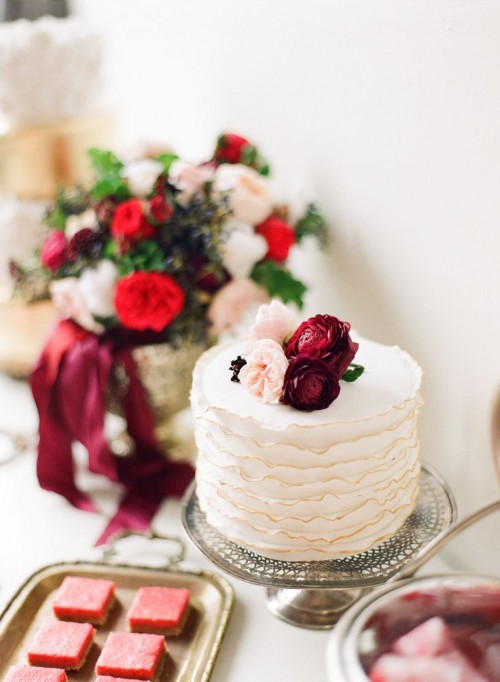 a textural ruffle wedding cake topped with blush and marsala blooms is a very chic and pretty idea to keep the color scheme up