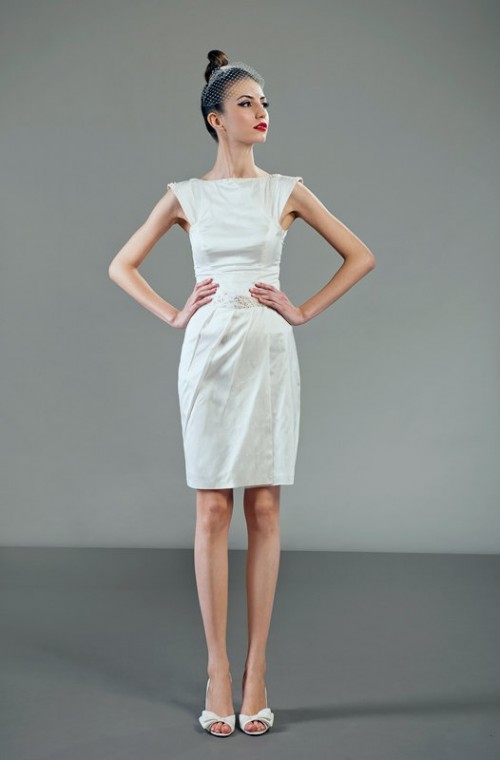 a minimalist knee wedding dress with a plain bodice and a pleated skirt, cap sleeves for a modern and fresh look