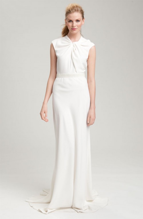 a minimalist wedding dress with a tied and draped bodice with cap sleeves and a maxi skirt with a train