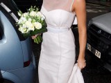 a minimal wedding dress with no sleeves and an illusion neckline plus a sash for a chic modern look