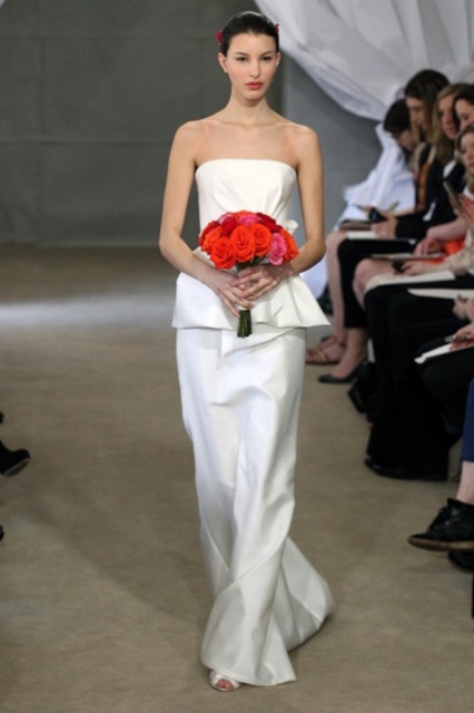 a minimalist strapless wedding dress with draperies and a train for a modern and simple look