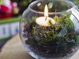 a woodland wedding centerpiece of a tree slice, a bowl with moss and a candle is easy to make
