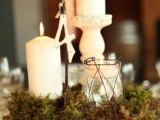 a tree slice covered with moss, with candles, a table number is a lovely idea for a vintage meets woodland wedding